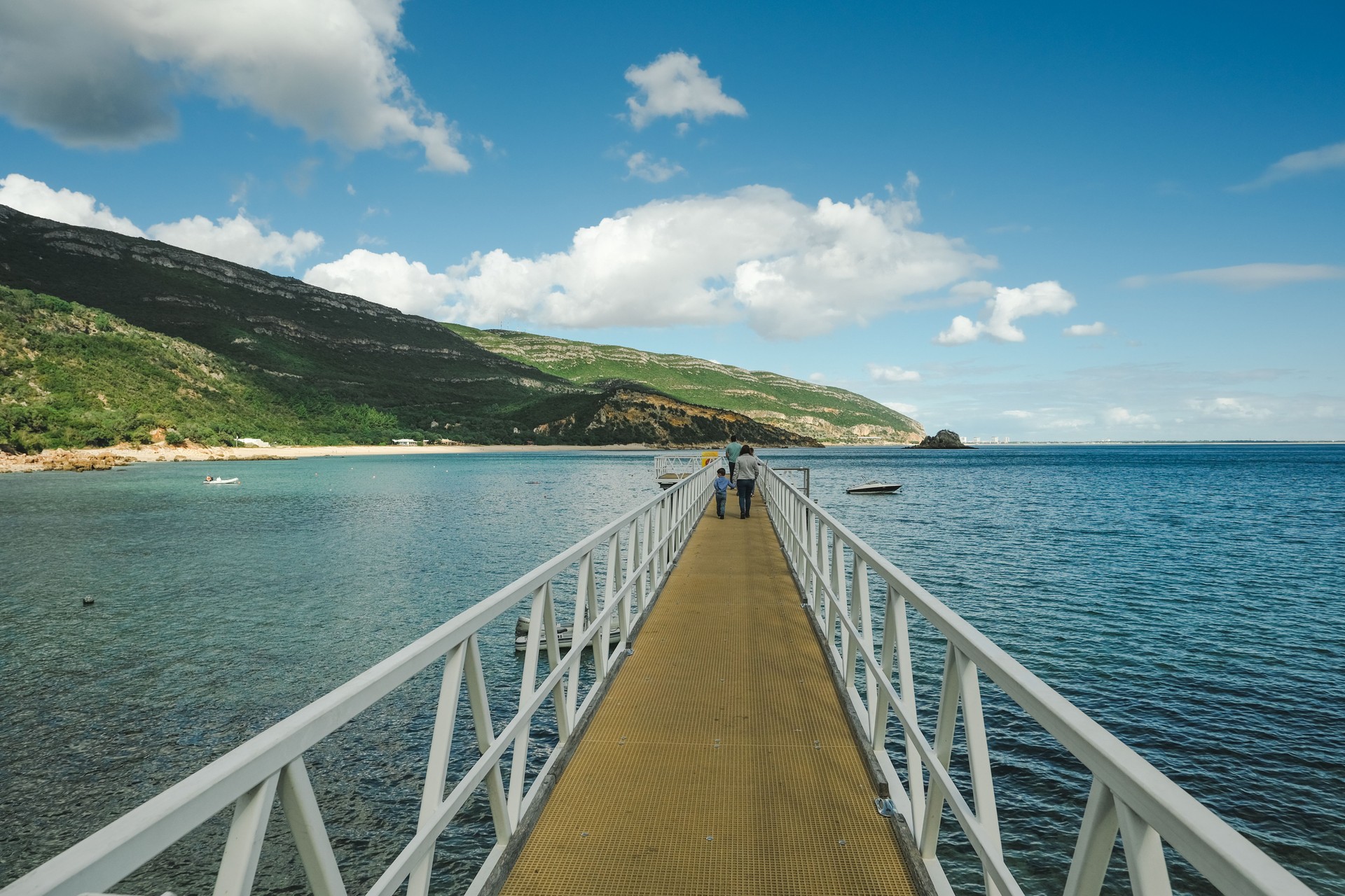 People walking in a Pier. Portinho da Arrabida beach in Setubal portugal.