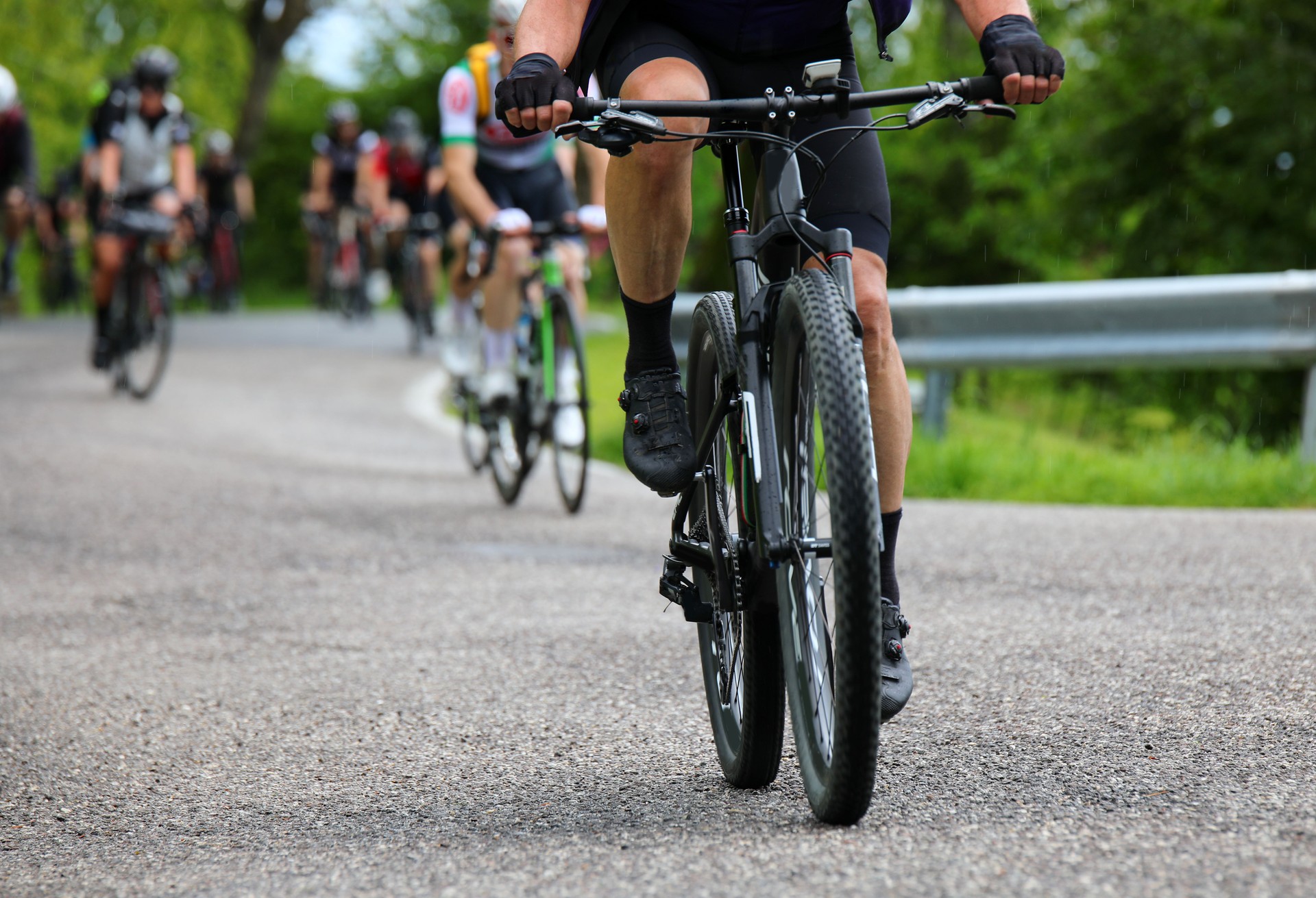 Gravel bike racing on mixed terrain with other cyclists