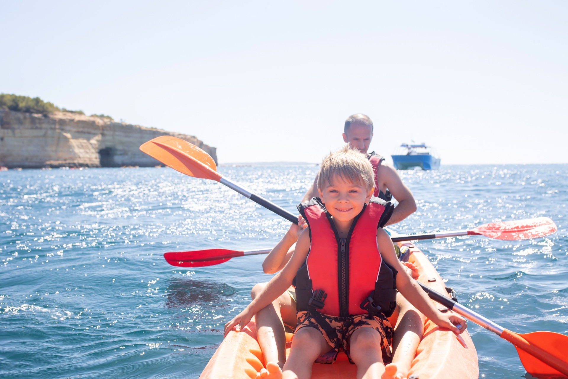 Children, enjoying Benagil, Portugal. Benagil Cave inside Algar de Benagil, famous sea cave in Algarve coast, Lagoa.